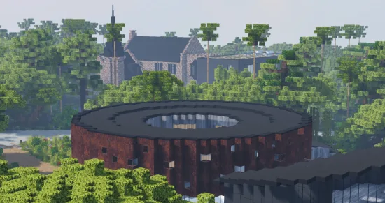 Bâtiment circulaire en brique sombre au milieu des arbres, manoir au fond