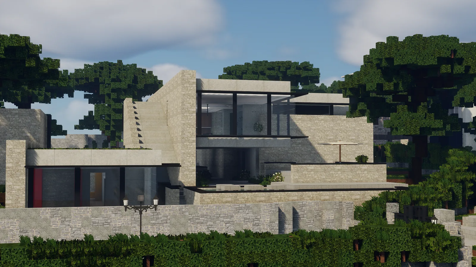Villa moderne en pierre claire à étages, entourée de végétation